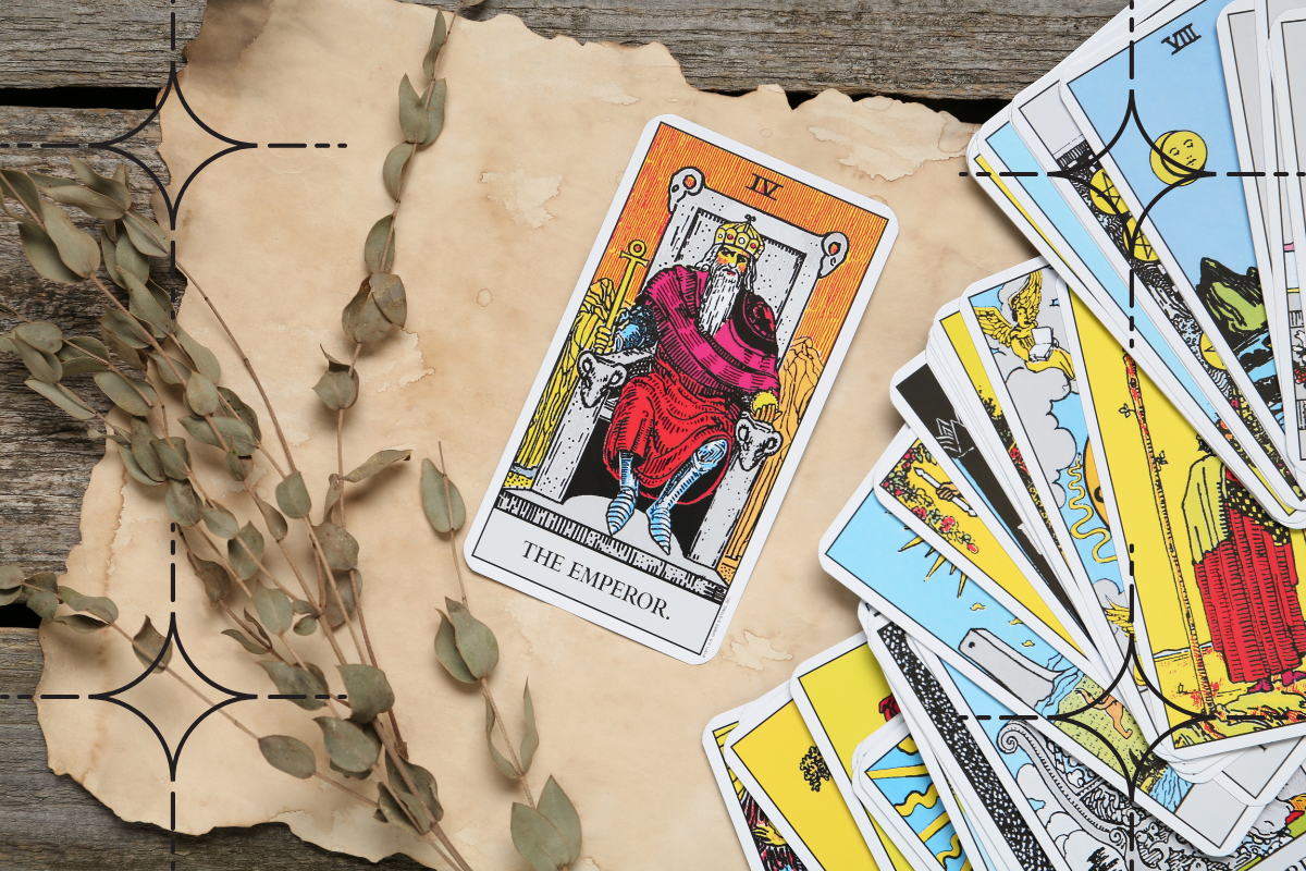 the emperor tarot card is laid down on a table. it is a man with a crown and sitting on a throne.
