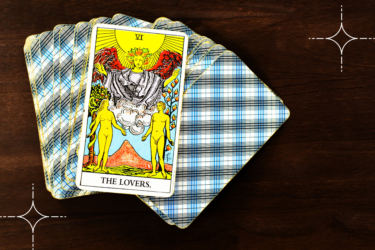 the lovers tarot card is laying face up.