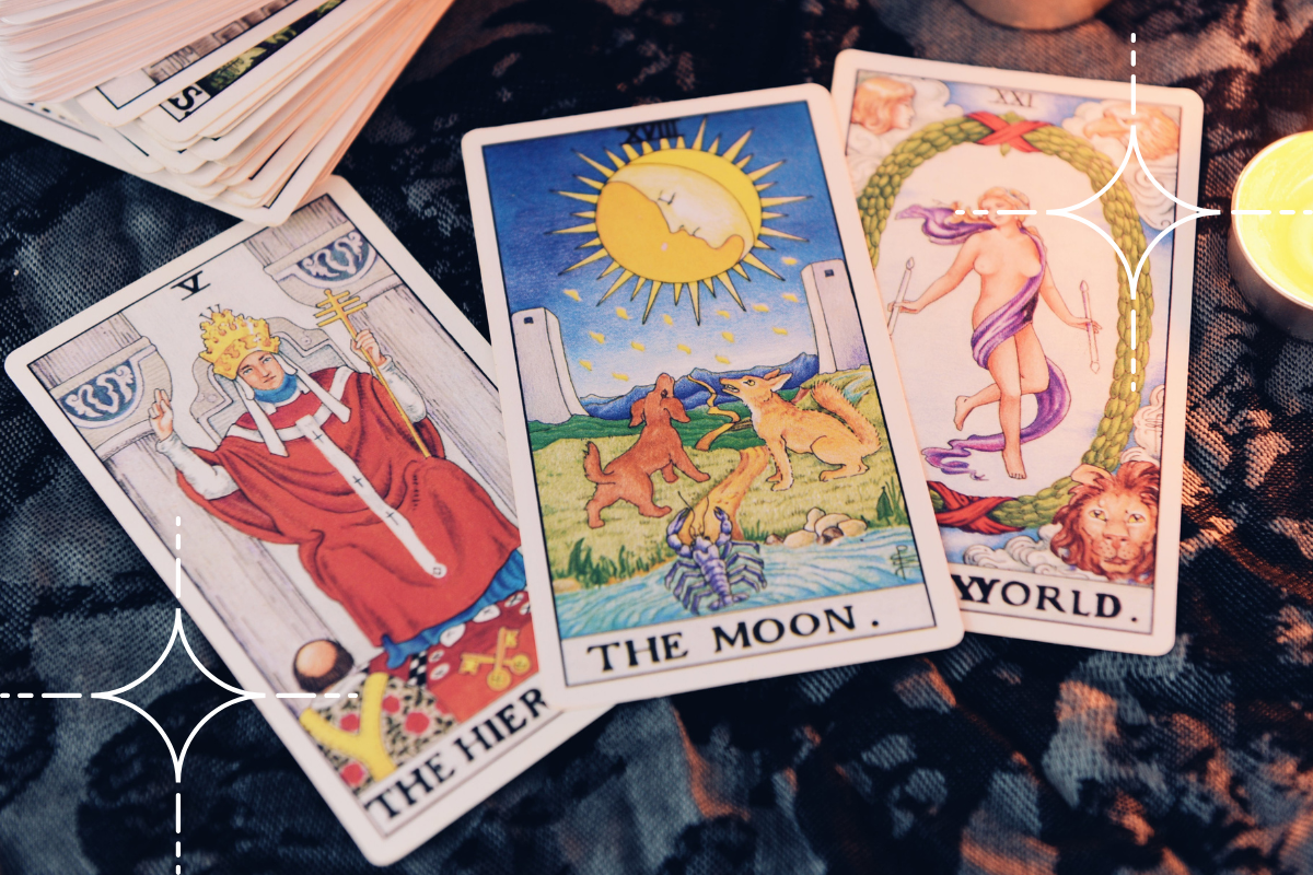 the moon tarot card laid out on a table with the hierophant and the world tarot cards.